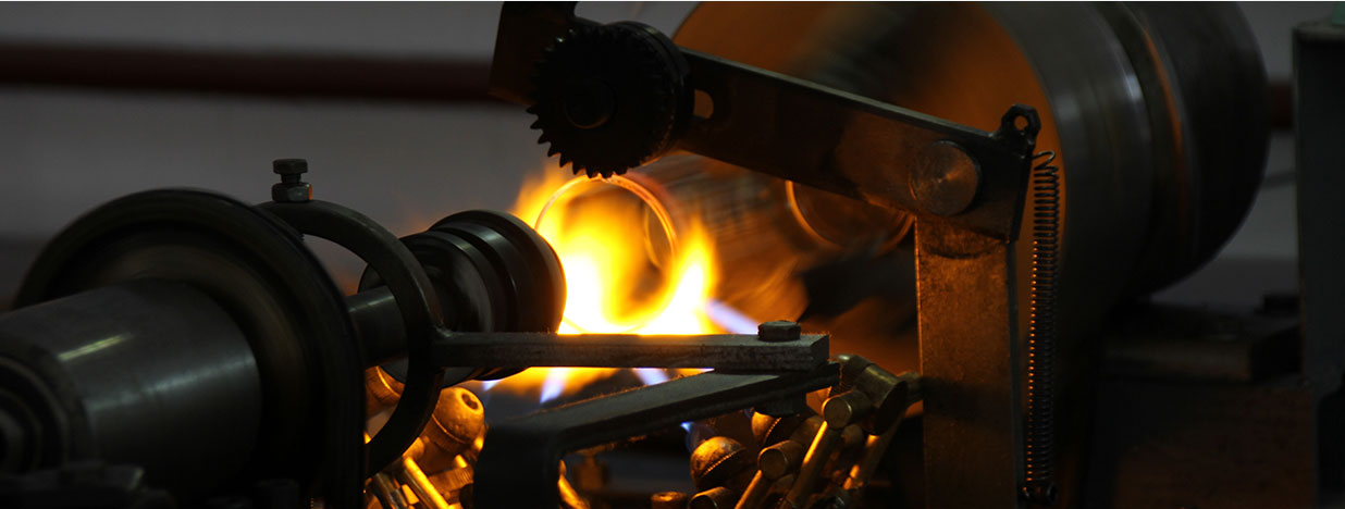 Glass being worked at a heated rim-finishing station