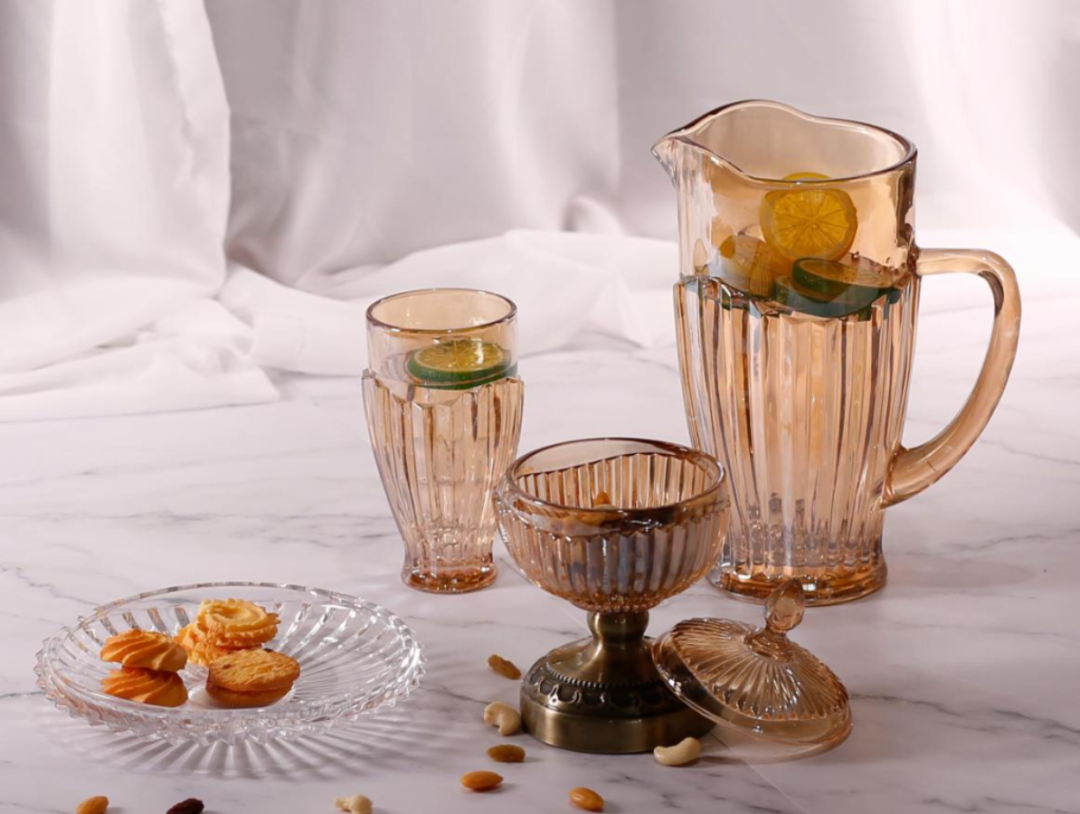 Amber-toned glass pitcher, tumbler, dessert cup and a clear serving plate