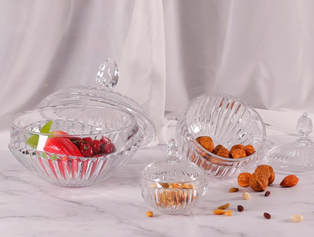 Clear patterned glass bowls with knobbed lids in a serving arrangement