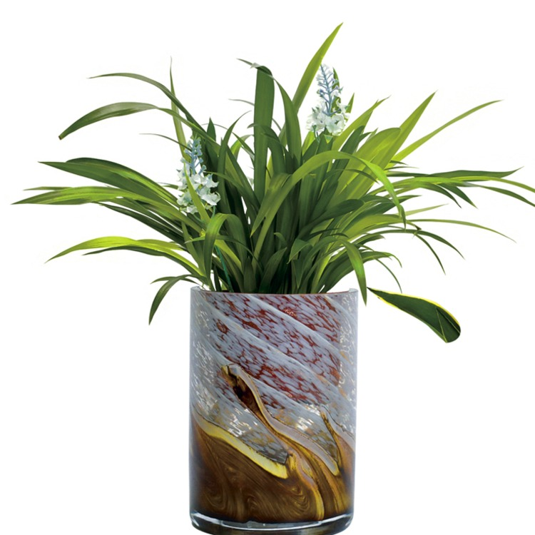 Patterned cylindrical glass vase shown with green foliage