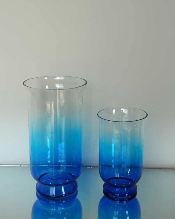 Blue-gradient open glass vessels with raised bases