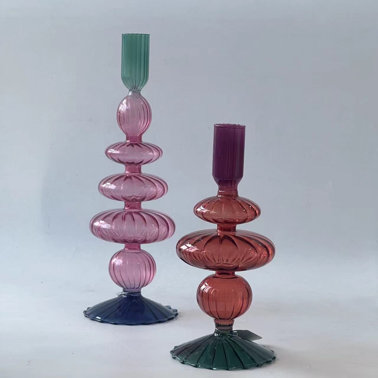 Two coloured sculptural glass candleholders with ribbed sections