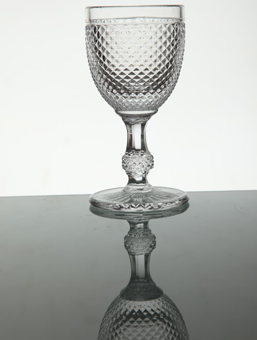 Patterned clear stemmed glass with a detailed foot