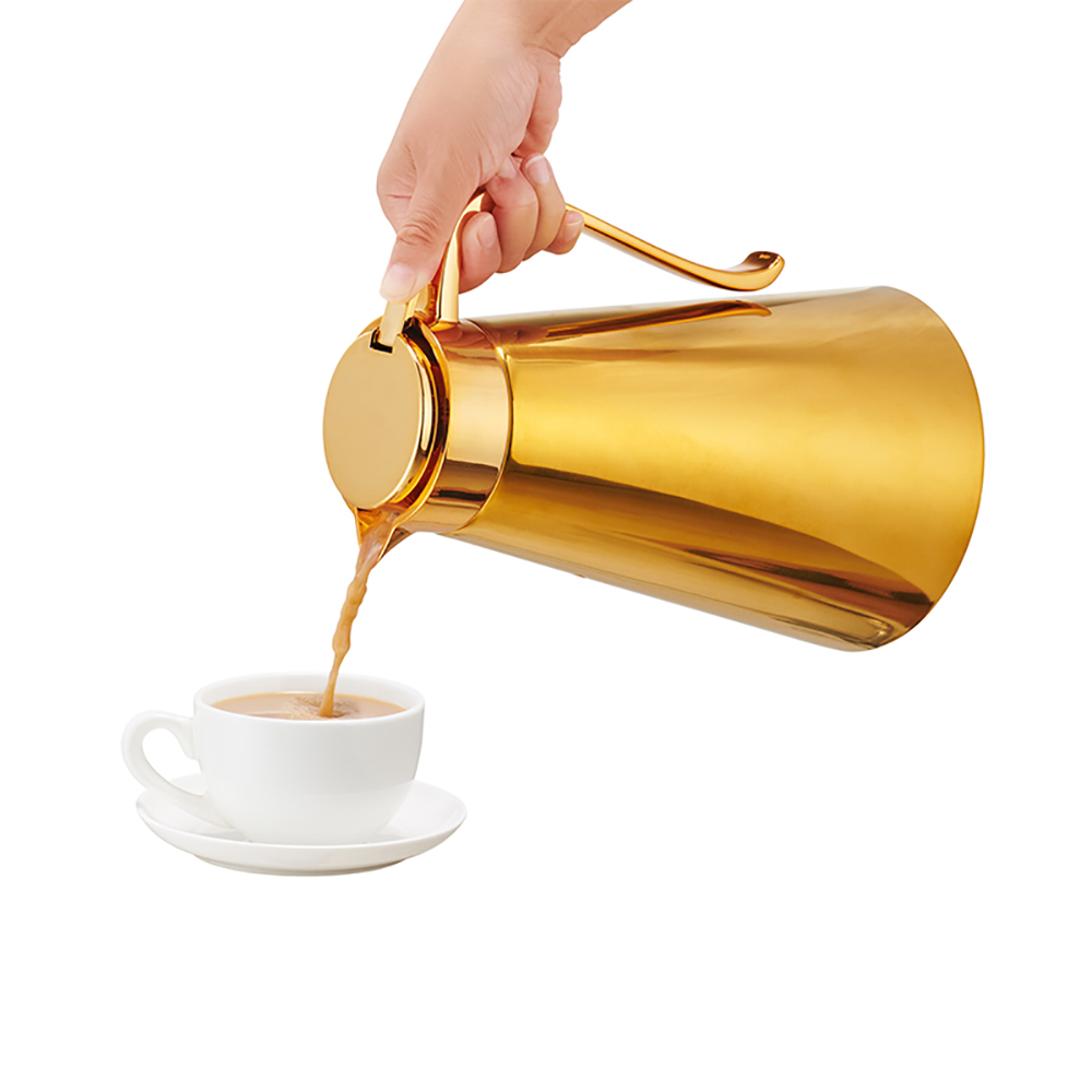 Gold-tone handled glass-refill coffee jug pouring into a cup