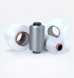 Unmarked filament yarn packages on a plain background